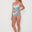 Woman wearing a blue and white patterned bikini on a white background